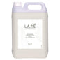 Le bidon de 5 litres de LAPE Earth Collection Sakura Sea Breeze Hand & Body Lotion de Diversey Deutschland a un parfum floral et frais, une poignée, un bouchon à vis et une étiquette blanche avec du texte noir et des motifs de lignes abstraites.
