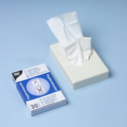 Un distributeur de mouchoirs blanc se tient à côté d'une boîte distributrice Starpak de 30 sacs hygiéniques (28,5 x 8 x 7 cm, blanc), qui contient 30 sacs hygiéniques avec des images d'instructions sur une surface bleu clair.
