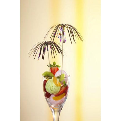 Un verre à dessert en verre avec de la glace verte, des fraises, du kiwi et de l'orange est couronné de deux PAPSTAR 100 piques de décoration de PAPSTAR GmbH au design de feu d'artifice – idéal pour une présentation élégante sur un dégradé de jaune.