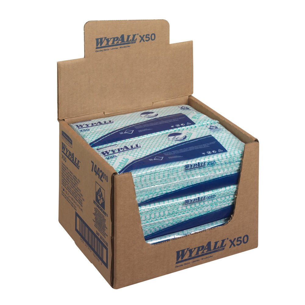 Une boîte distributrice de Kimberly-Clark GmbH contient 6 sachets de lingettes WypAll® X50 Critical Clean Interfold Green (50 feuilles chacune) ; plusieurs paquets sont visibles, et le carton montre les détails du produit et le marquage pour un nettoyage professionnel.