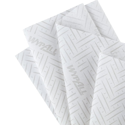 Quatre essuie-tout WypAll® L10 de Kimberly-Clark GmbH avec un motif Chevron gris sont illustrés en chevauchement - idéaux comme recharges Centrefeed pour les distributeurs Reach+™ dans le nettoyage des services et du commerce de détail. Taille : 38,00 x 18,30 cm.