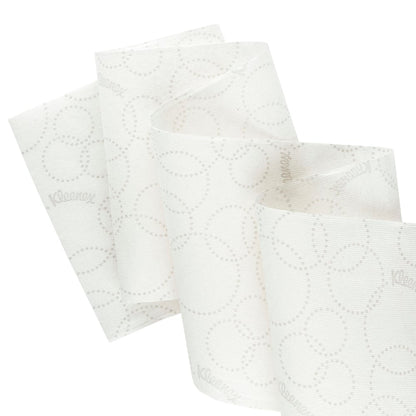 Gros plan d'un rouleau de serviettes blanches Kleenex® Ultra™ Slimroll™ de Kimberly-Clark GmbH avec un motif discret de points et un déroulement partiel, pour montrer son adaptation aux systèmes de distribution étroits; 6 rouleaux par carton.