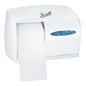 Le distributeur de papier toilette Kimberly-Clark Professional™ en blanc contient du papier toilette sans noyau et des serviettes en papier pliées, tous deux visibles à travers une fenêtre ovale, offrant une solution durable pour les salles de bain.
