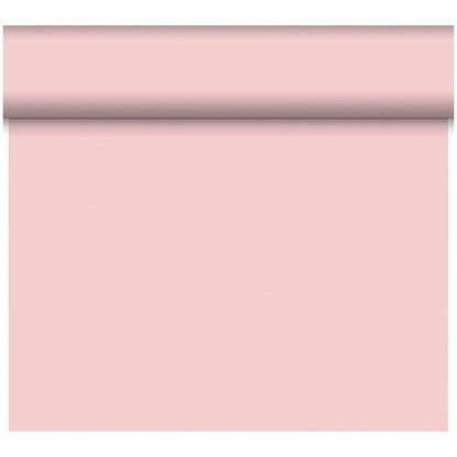Un rouleau de papier peint rose clair Bio-DC-Tete a Tete 0,4x24m de Duni GmbH est partiellement déroulé, révélant sa surface lisse et solide ; la partie supérieure reste enroulée tandis que le reste pend verticalement.