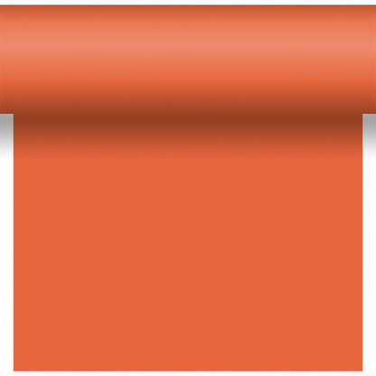 Un rouleau de Bio-DC-Tete a Tete 0,4x24m de Duni GmbH en orange, partiellement déroulé vers le bas sur un fond blanc avec une ombre près du bord supérieur ondulé.