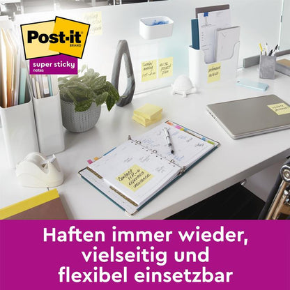 Sur un bureau moderne se trouvent un planificateur, un ordinateur portable, un dévidoir de ruban adhésif, une plante en pot et des Post-it® Super Sticky Notes (76 mm x 127 mm, 90 feuilles/bloc, 100% PEFC) de 3M Deutschland GmbH; en dessous il est écrit : "Adhèrent à nouveau, polyvalent et flexible à utiliser."