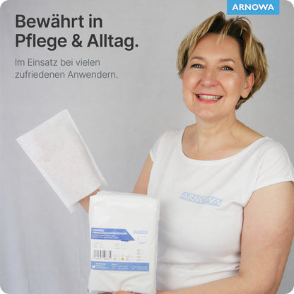 Eine lächelnde Frau in einem weißen Hemd hält ARNOMED Einmalwaschhandschuhe aus Molton von ARNOWA GmbH (Beutel, 50 Stück) mit Dermatest-Siegel. Text: "Bewährt in Pflege & Alltag" - ideal für die sanfte Hautpflege.