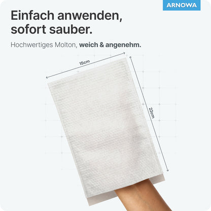 Une main porte un gant de toilette jetable ARNOMED blanc en molleton (75g/m², 15x22 cm) de ARNOWA GmbH, présenté sur un fond clair. En haut à droite, on peut voir le texte allemand, le sceau Dermatest et le logo bleu ARNOVA. Paquet: 50 pièces.