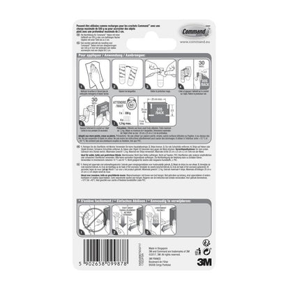 Au dos d'un paquet de la 3M Deutschland GmbH Petite Command™ Strips S, 17022N se trouvent des instructions illustrées et multilingues pour appliquer et retirer les bandes adhésives sans clous, afin de préserver les murs sans dommage, ainsi qu'un code-barres au bas.