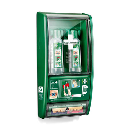 Die Orkla Wound Care AB Cederroth Augenspülstation besteht aus zwei 500-ml-Flaschen (725200) und einem Salvequick Pflasterspender (490700), die alle hinter einer durchsichtigen Abdeckung an der Wand befestigt sind, auf der die Gebrauchsanweisung und der Markenname sichtbar sind.