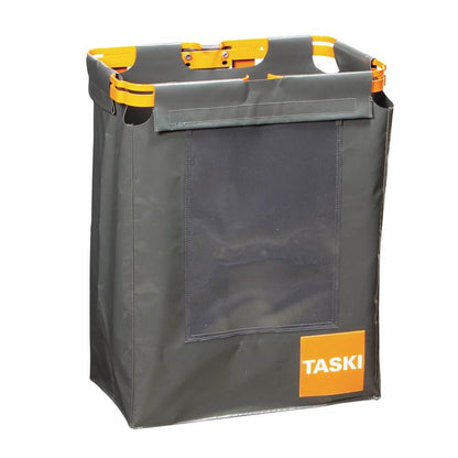 Le sac TASKI pour sacs à déchets de Diversey Deutschland GmbH & Co. OHG est un conteneur rectangulaire en tissu gris foncé avec des poignées orange, un cadre orange, une poche avant transparente et une étiquette TASKI - parfait pour l'élimination hygiénique des déchets.