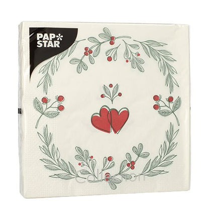 PAPSTAR 20 serviettes, 33x33 cm, 3 plis de PAPSTAR GmbH (Design Set 6) montrent une serviette blanche avec une couronne de feuilles vertes et de baies rouges, des cœurs rouges au centre et une étiquette "PAP STAR" noire en haut à gauche.