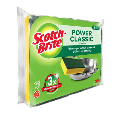 Illustré est un emballage de l'éponge de nettoyage Scotch-Brite® Classic de 3M Deutschland GmbH avec deux éponges. Sur l'emballage principalement vert, une éponge et une casserole en métal sont illustrées, avec du texte en anglais et en allemand.