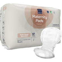 Un paquet de serviettes maternité ABENA, Premium (15 pièces) de Abena Re-Seller GmbH offre des serviettes douces et super absorbantes, conçues pour une utilisation post-partum - des serviettes de maternité idéales pour un confort maximal après l'accouchement, avec une serviette ouverte illustrée à l'avant.