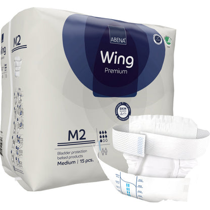 Un paquet de Abena Re-Seller GmbH ABENA Wing Premium, contenant 15 produits d'incontinence de taille moyenne avec ceinture, est illustré. Un produit est affiché à l'avant, mettant en avant la protection ultime pour adultes.