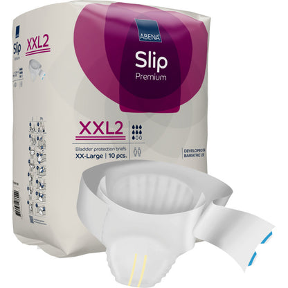 Un paquet de ABENA Slip Premium de Abena Re-Seller GmbH est exposé, un slip partiellement déballé est placé devant. L'emballage violet et blanc met en avant la taille XX-Large, 10 pièces, et la prise en charge fiable de l'incontinence.