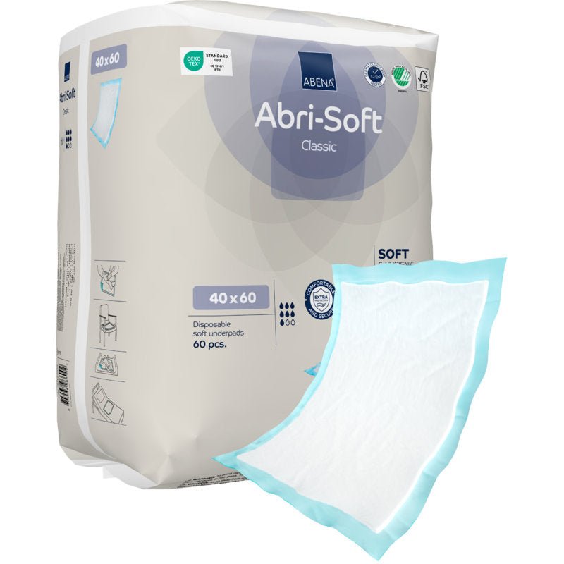 L'image montre un paquet de 60 protections jetables Abri-Soft Classic (40x60 cm, bleu) de Abena Re-Seller GmbH avec une protection en dehors de l'emballage avec un noyau absorbant blanc et un bord bleu.
