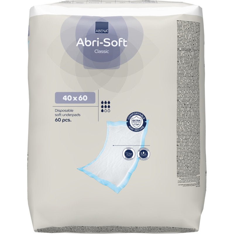 Un paquet de protections jetables Abri-Soft Classic, 40x60 cm, Bleu (60 pièces) de Abena Re-Seller GmbH. L'emballage présente des détails du produit, des symboles et un croquis de la protection.
