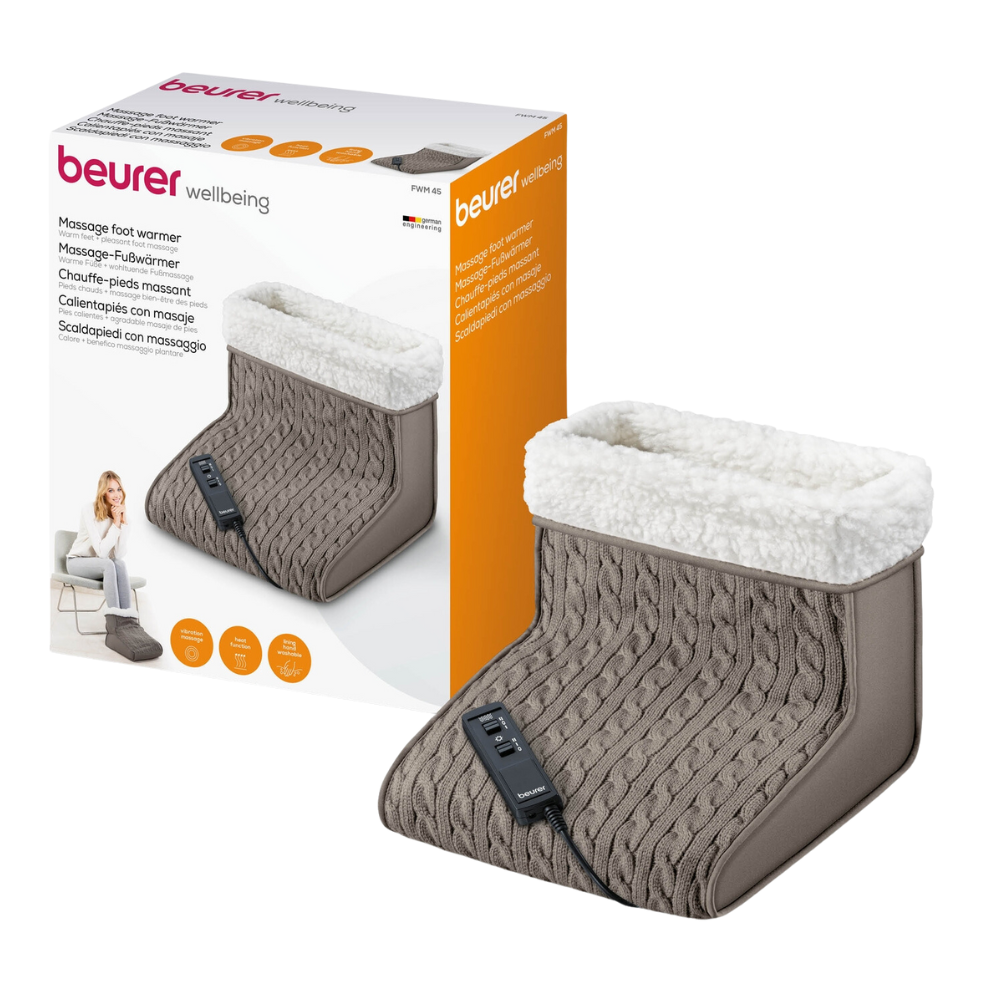 Exposé est un Beurer FWM 45 chauffe-pieds de massage emballé de Beurer GmbH. La boîte blanche montre une image du produit et une femme qui l'utilise. Le chauffe-pieds est en tricot gris avec une doublure en peluche blanche et une unité de commande noire pour des niveaux de chaleur réglables. Le nom du produit « Beurer FWM 45 chauffe-pieds de massage | Emballage (1 pièce) » est imprimé en plusieurs langues.