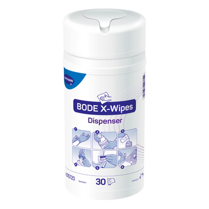 Image produit d'un distributeur de désinfectant Hartmann BODE X-Wipes avec 30 lingettes, avec des symboles illustrant différentes utilisations et domaines tels que la santé et les surfaces, sur une étiquette blanche et violette de Paul Hartmann AG.