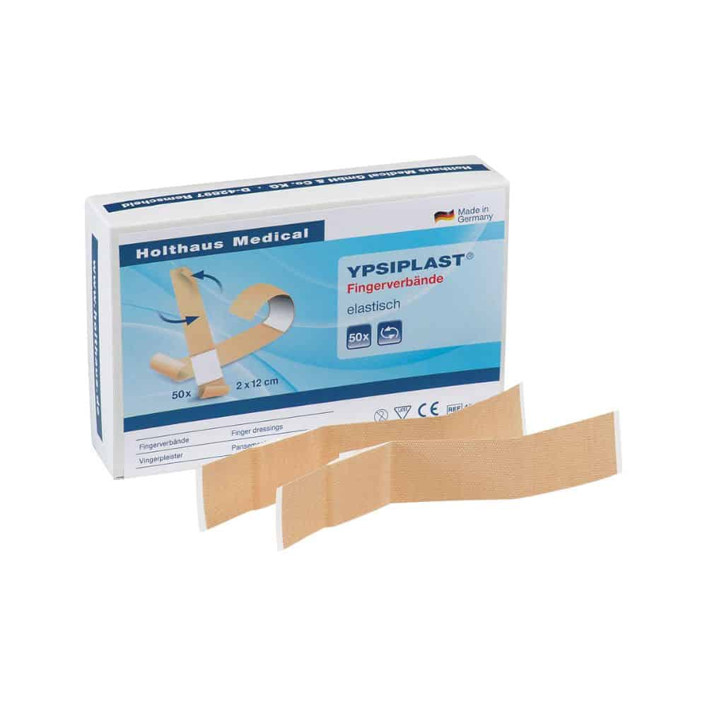 Exposée est une boîte de pansements pour doigts élastiques Holthaus Medical YPSIPLAST® de Holthaus Medical GmbH & Co. KG, contenant 50 bandages élastiques de dimensions 2 cm x 12 cm. Devant la boîte sont placés deux pansements pour doigts élastiques. Sur l'emballage, il est fièrement indiqué „Fabriqué en Allemagne“.