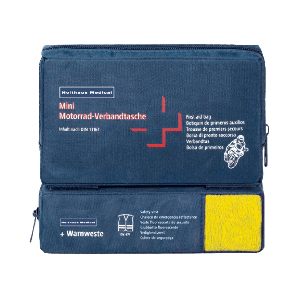 Un kit de premiers secours bleu avec l'inscription « Holthaus Mini Combi Verbandtasche Motorrad » de Holthaus Medical GmbH & Co. KG avec un texte multilingue pour les motos. Il est conforme à la norme DIN 13167 et contient un gilet de sécurité visible à travers une section transparente. La Mini Combi Verbandtasche dispose de deux compartiments à fermeture éclair - un en haut et un sur le côté.