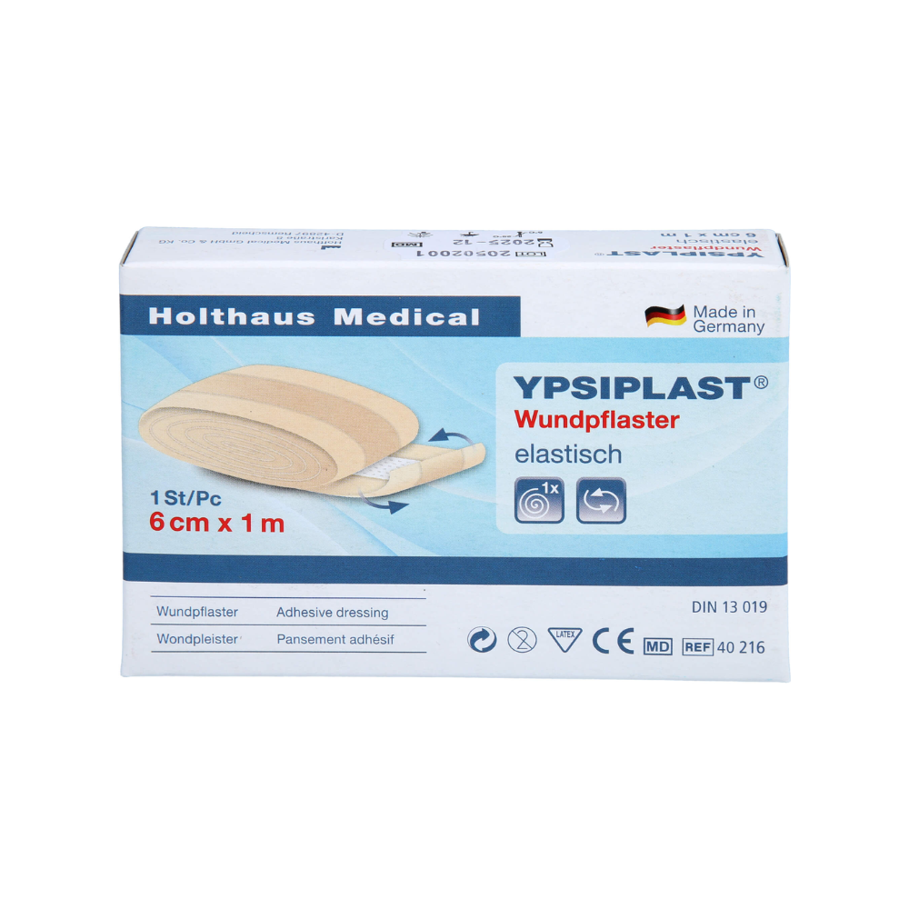 L'image montre une boîte de pansements élastiques Holthaus Ypsiplast® - 6 cm x 1 m de Holthaus Medical GmbH & Co. KG. La boîte contient une seule pièce de sparadrap élastique et indique qu'elle est fabriquée en Allemagne à partir de tissu respirant. De plus, plusieurs symboles et spécifications du produit sont visibles.