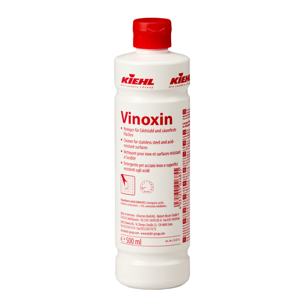 Bouteille blanche de 500 ml Johannes Kiehl KG Vinoxin nettoyant pour acier inoxydable et surfaces résistantes aux acides, avec bouchon rouge et étiquette avec instructions d'utilisation et informations sur le produit. Disponible en cartons de 12 bouteilles.
