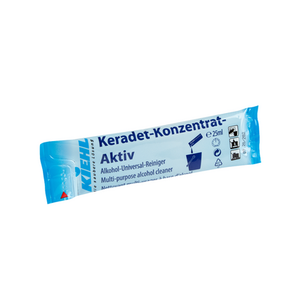 Un sachet bleu et blanc avec l'inscription "Kiehl Keradet-Concentré-Actif Nettoyant Universel à l'Alcool" de Johannes Kiehl KG contient 25 ml de nettoyant pour des résultats sans traces, avec des pictogrammes pour une utilisation domestique et des consignes de sécurité.