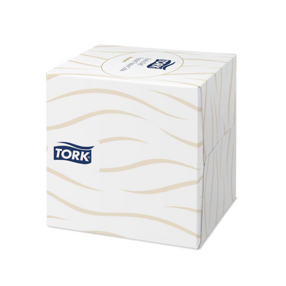 Un cube distributeur de mouchoirs Tork 140278 Tork extra doux en blanc avec un motif ondulé beige et le logo TORK sur le côté.