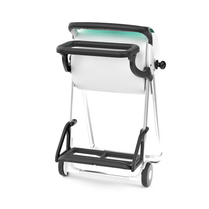 Un support de sac poubelle Tork 206550 pour support de sol en blanc et noir, avec des roues, une poignée et un rouleau de papier ou de tissu positionné au centre. La structure métallique ressemble à un support de sol et montre le support de sac poubelle Tork sous un angle légèrement incliné.