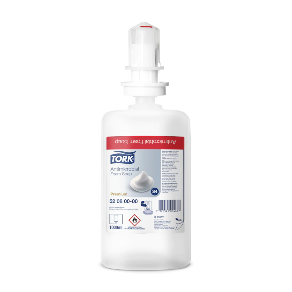Un flacon de savon mousse Tork 520800 de 1000 ml pour la décontamination des mains Premium S4 de TORK - Essity Professional Hygiene Germany GmbH, avec une pompe blanche et une étiquette rouge. Certifié EN 1499, idéal pour une décontamination efficace des mains.