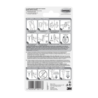 Rückseite einer Command™ Medium Designer-Haken, 17081-FGN-Verpackung der 3M Deutschland GmbH mit bebilderter Schritt-für-Schritt-Klebestreifen-Anleitung, mehrsprachigem Text, 3M-Logo, Website, Barcode und einem Tipp zur Haushaltsorganisation (Haken Aufbewahrung).