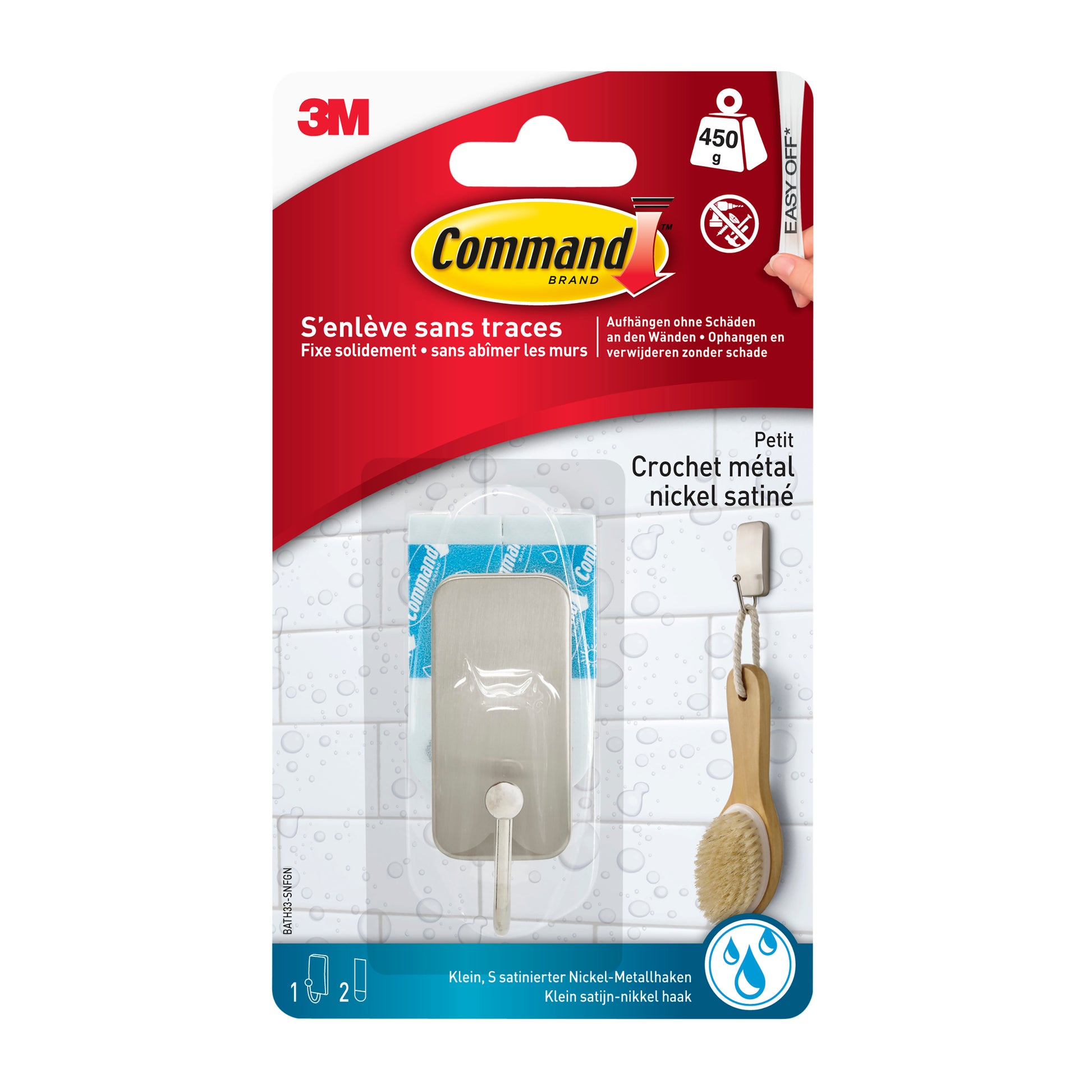 Der Command™ Metall-Haken Bad, schmal, Satin Nickel (1 Haken, 25 Stips) von 3M Deutschland GmbH ist ideal für die Aufbewahrung im Badezimmer. Die Verpackung enthält französische Informationen und Bilder von einer Bürste und einem Handtuch, die ohne Bohren am Haken hängen.