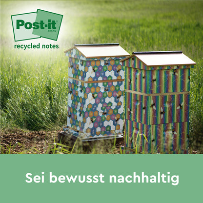 Zwei bunte Bienenstöcke stehen auf einer Wiese im Sonnenlicht. Das Logo von Post-it® Super Sticky 100% Recycling Notes (3M Deutschland GmbH) befindet sich oben links. Unten steht der Text "Sei bewusst nachhaltig" in deutscher Sprache.