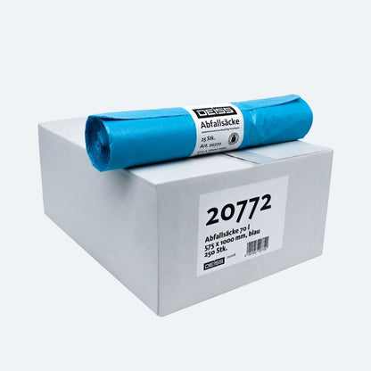 Sur un carton blanc avec l'inscription « 20772 » se trouve un rouleau de sacs-poubelle bleus, connus pour leur résistance à la déchirure. Le carton contient 25 sacs-poubelle de la collection DEISS LDPE Type 60, mesurant 575 x 1100 mm. Sur l'étiquette, le nom de la marque « EMIL DEISS KG (GmbH + Co.) » est visible.